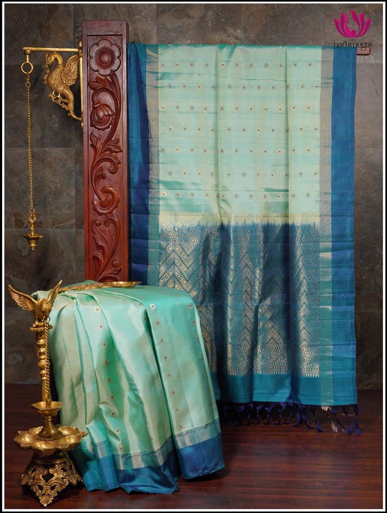 Borderless peacock blue Kancheepuram silk saree with big & small size leaf  designs on its body, pallu with leaves